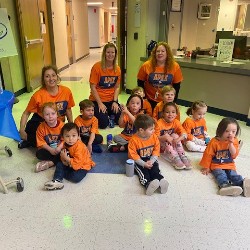 Preschoolers after the fun run sitting on the floor